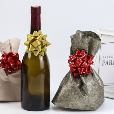 Étoile d'or présent ruban arc vin rouge cadeau emballage ruban arc